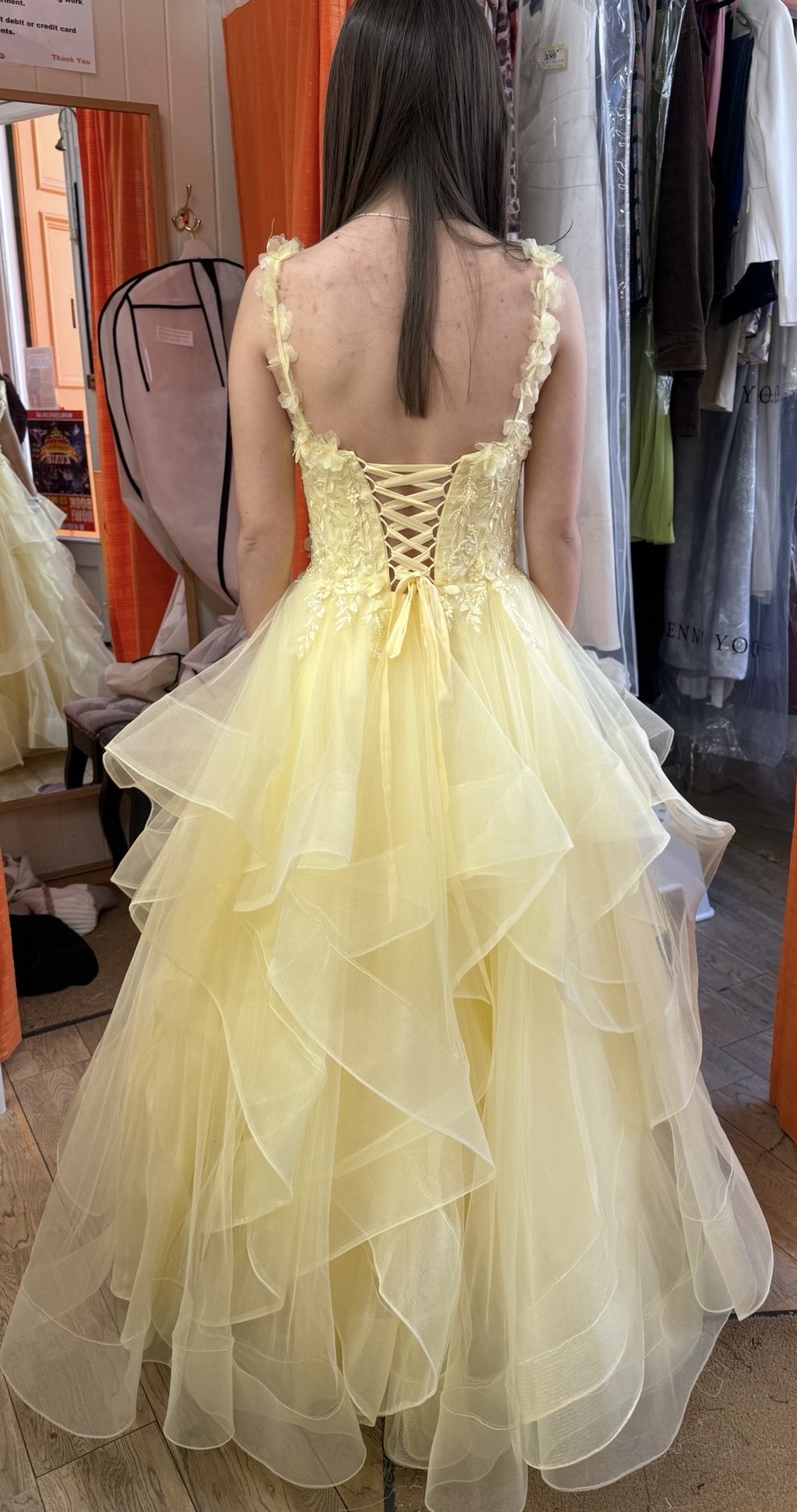 Yellow ruffled prom gown, laced back view